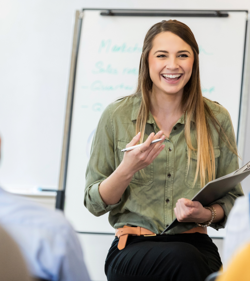 two colleagues practising language conversation using flashcards